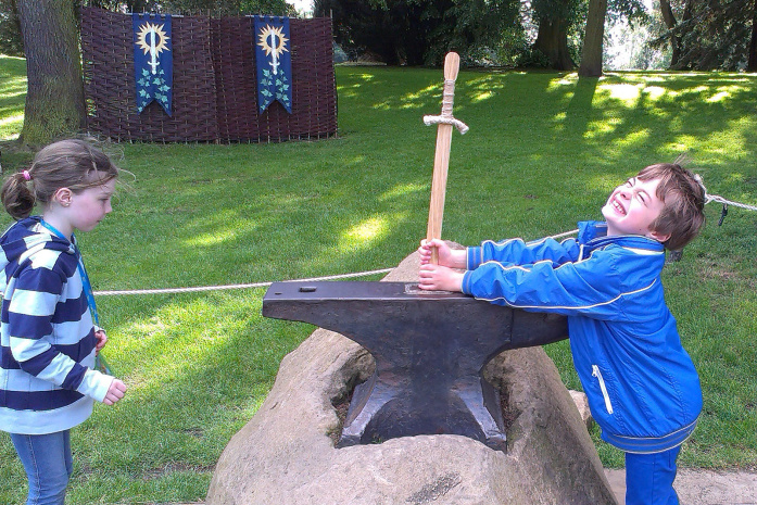 Pulling the sword from the anvil at Warwick Castle -© David Else - Lonely Planet