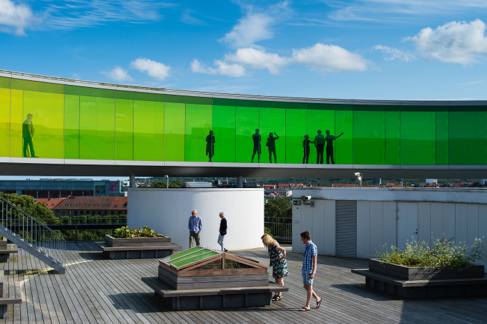 Visitors explore the roof of ARoS Aarhus Kunstmuseum and Olafur Eliasson's Your Rainbow Panorama © Rudy Mareel - Shutterstock Images